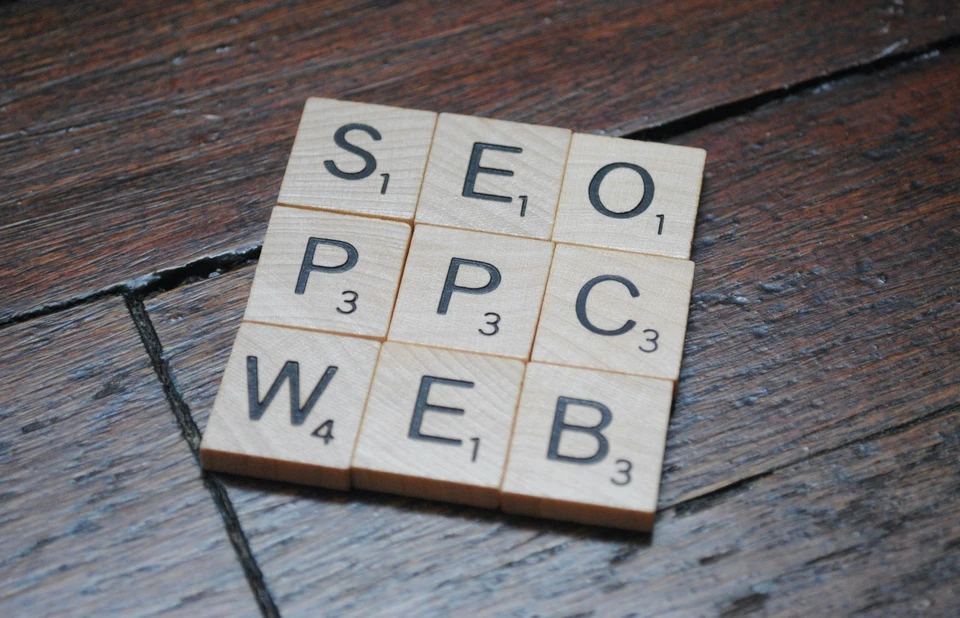 search engine optimization and pay per click concept with wooden tiles